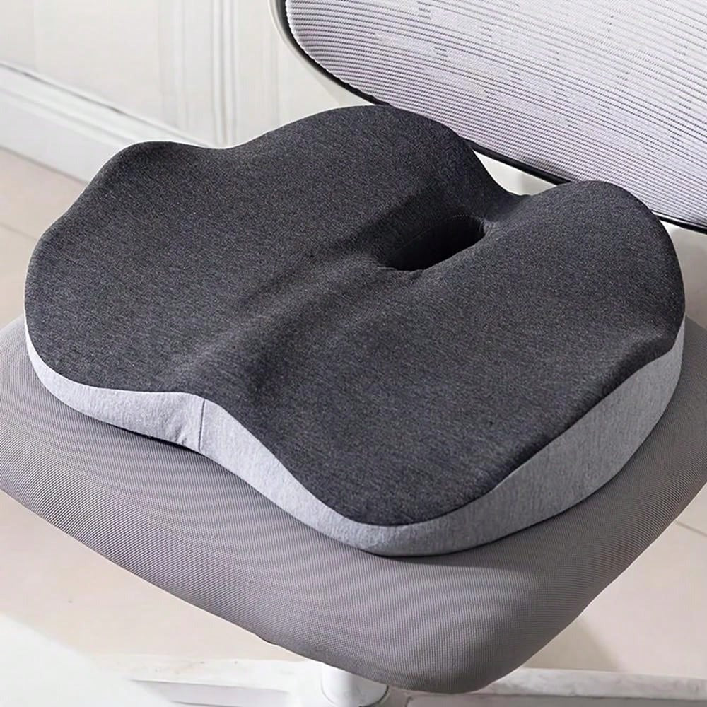 Grey orthopedic memory foam coccyx cushion for lumbar support on an office chair by TU SHOP