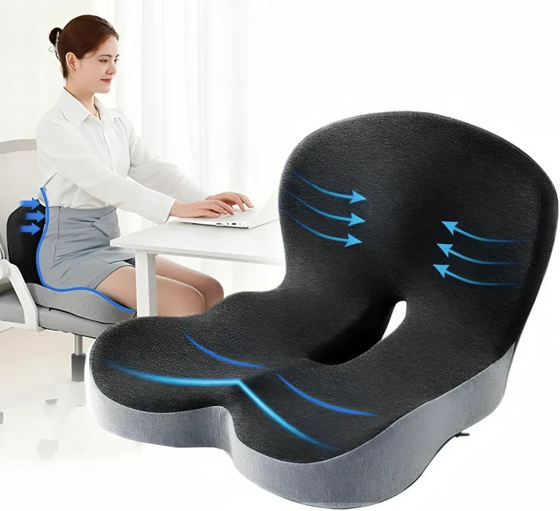 Orthopedic seat cushion for lumbar support and comfort while working on a laptop.