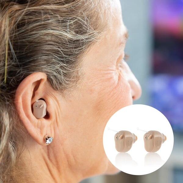 Senior woman wearing TU SHOP CIC micro hearing aids for clear sound.